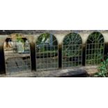 ARCHITECTURAL GARDEN MIRRORS, a set of four, aged metal frames, 78cm x 49cm. (4)