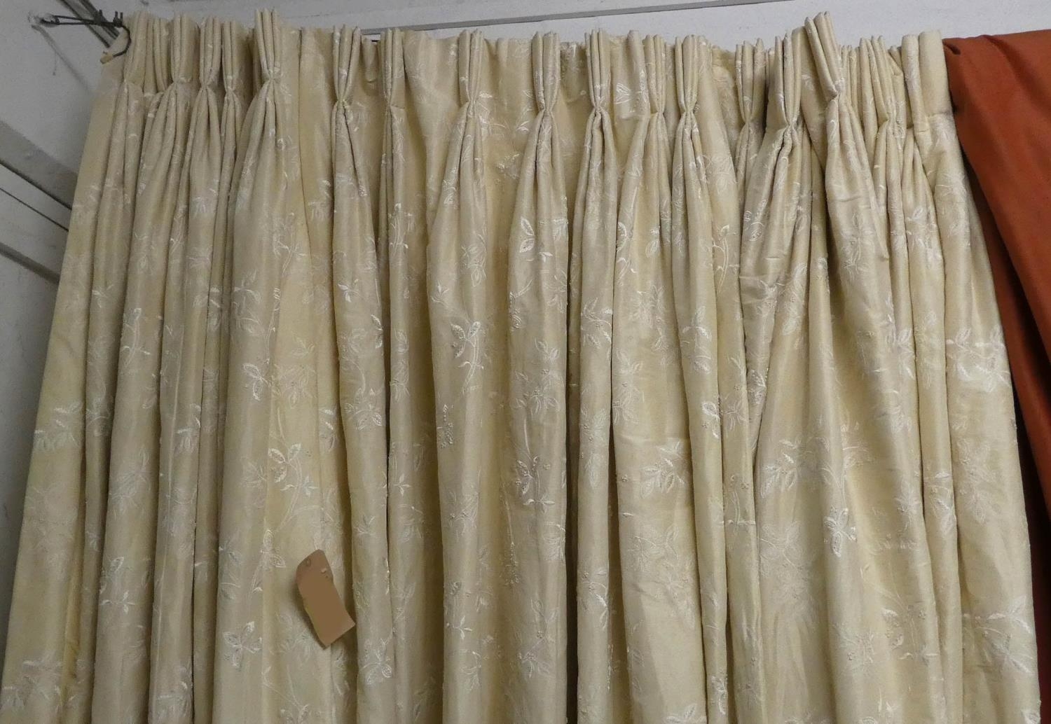 CURTAINS, two pairs in an embroidered ivory silk, lined and interlined, one pair each curtain approx