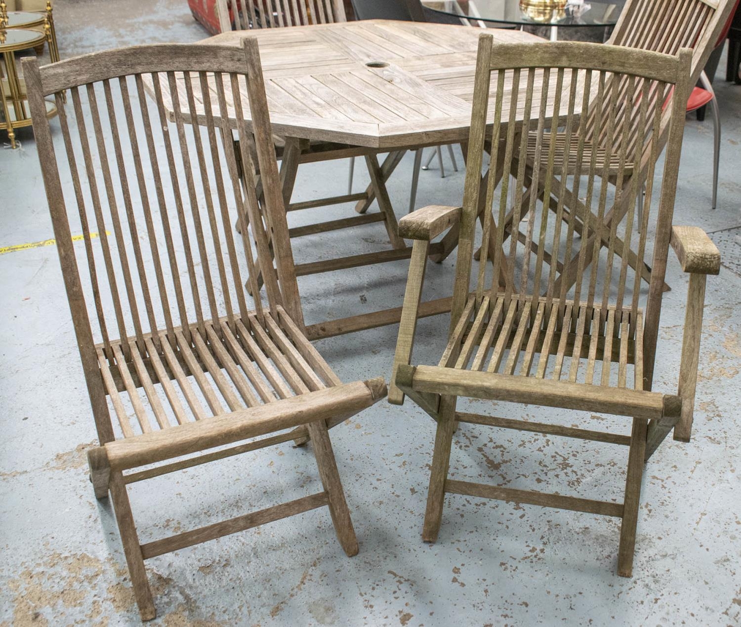 GARDEN TABLE, octagonal weathered teak on folding legs, 74cm H x 120cm W and a set of four folding - Image 2 of 2