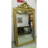 WALL MIRROR, 19th century French, gilt with swags and crest detail, 158cm x 83cm.
