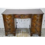 SERPENTINE DESK, Georgian style, mahogany, with burgundy leather top above nine drawers, 75cm H x