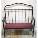 BENCH, late 19th century black cast iron with striped seat, (adapted), 137cm H x 127cm W x 48cm D.