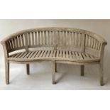 'BANANA' GARDEN BENCH, weathered teak slatted with bow back and rolled arms, 160cm W.