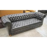 CHESTERFIELD SOFA, mid 20th century in old black leather on bun feet and castors, 238cm W.