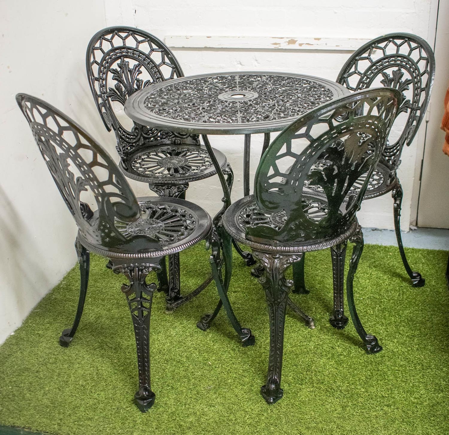 GARDEN SET INCLUDING TABLE, black painted metal with circular top, 69cm and a set of four chairs. (