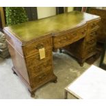 PEDESTAL DESK, early 20th century burr walnut of breakfront form with an inlaid green leather top