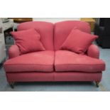 HOWARD STYLE SOFA, dusky pink covers with seat and scatter cushions on beech feet and brass castors,