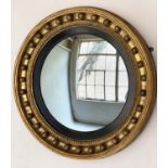 CONVEX WALL MIRROR, Regency period circular with sphere encrusted frame, ebonised slip and convex