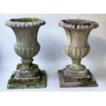 ARCHITECTURAL GARDEN URNS, a pair, well weathered reconstituted stone campana form with stepped