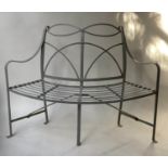 GARDEN TREE BENCH, weathered grey painted wrought iron with curved 'quarter' back, 118cm W.