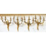 WALL LIGHTS, a set of four, Louis XV design gilt metal with three branches, 48cm H. (3)