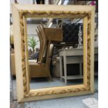 WALL MIRROR, early 20th century, the cream painted frame with carved gilt detail, 115cm W x 144cm H.