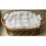 PAPASAN SOFA, rattan and cane bound two part with spiral rings and oval support, with cushions,