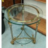 OCCASIONAL TABLE, brass and chrome framed with a circular glass top and undertier on wheels, 60cm