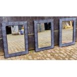 ARCHITECTURAL GARDEN WALL MIRRORS, a set of three, black painted Spanish style, 90cm x 63cm. (3)