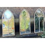 ARCHITECTURAL GARDEN MIRRORS, a set of three, Gothic style, aged metal frames, 112cm x 56cm. (3)