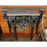 CONSOLE TABLE, with a metallic top on ebonised and gilt carved base with swagged detail, 111cm W x