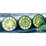 ARCHITECTURAL GARDEN WALL MIRRORS, a set of three, with Roman numeral detail, 80cm diam. (3)