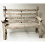 GARDEN BENCH, weathered teak of compact substantial form with flat top arms and rounded Lutyens