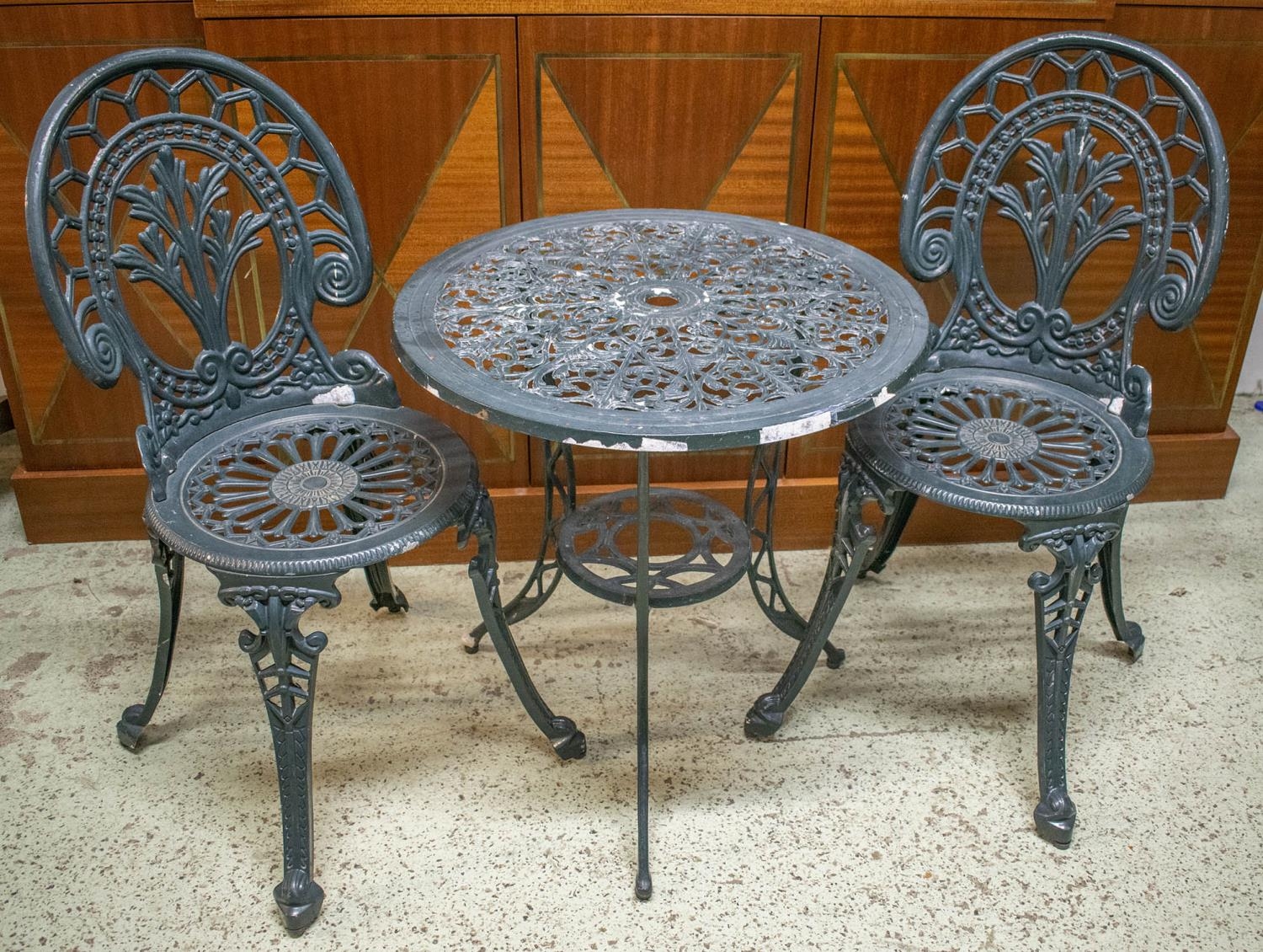 GARDEN SET, distressed painted metal table with circular top 63cm H x 61cm and a pair of chairs. (3)