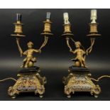 CANDELABRA, a pair, gilt metal cherubs on Boulle work style plinth bases, 33cm H. (2) (with faults)