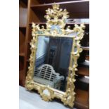 WALL MIRROR, 18th century style gilt framed with 'C' scroll, leaf and flowerhead decoration, 86cm