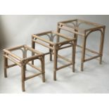 NEST OF TABLES, three rattan, glazed and cane bound, largest 58cm x 43cm x 59cm H. (3)