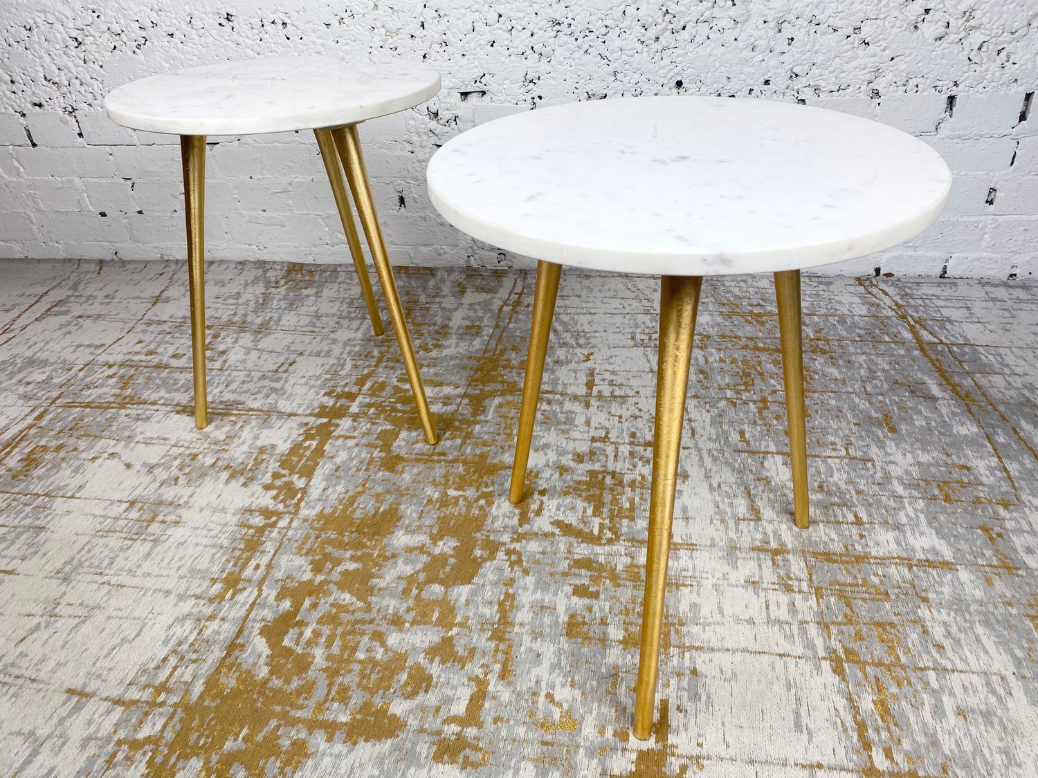 LAMP TABLES, a pair, 1970's Italian design, circular marble tops on tripod gilt metal legs, 47cm H x