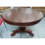 LOW TABLE, the circular mahogany top with brass trim on a faceted column and triform base with