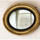 CONVEX WALL MIRROR, 19th century unusual oval giltwood and gesso moulded with sphere encrusted frame