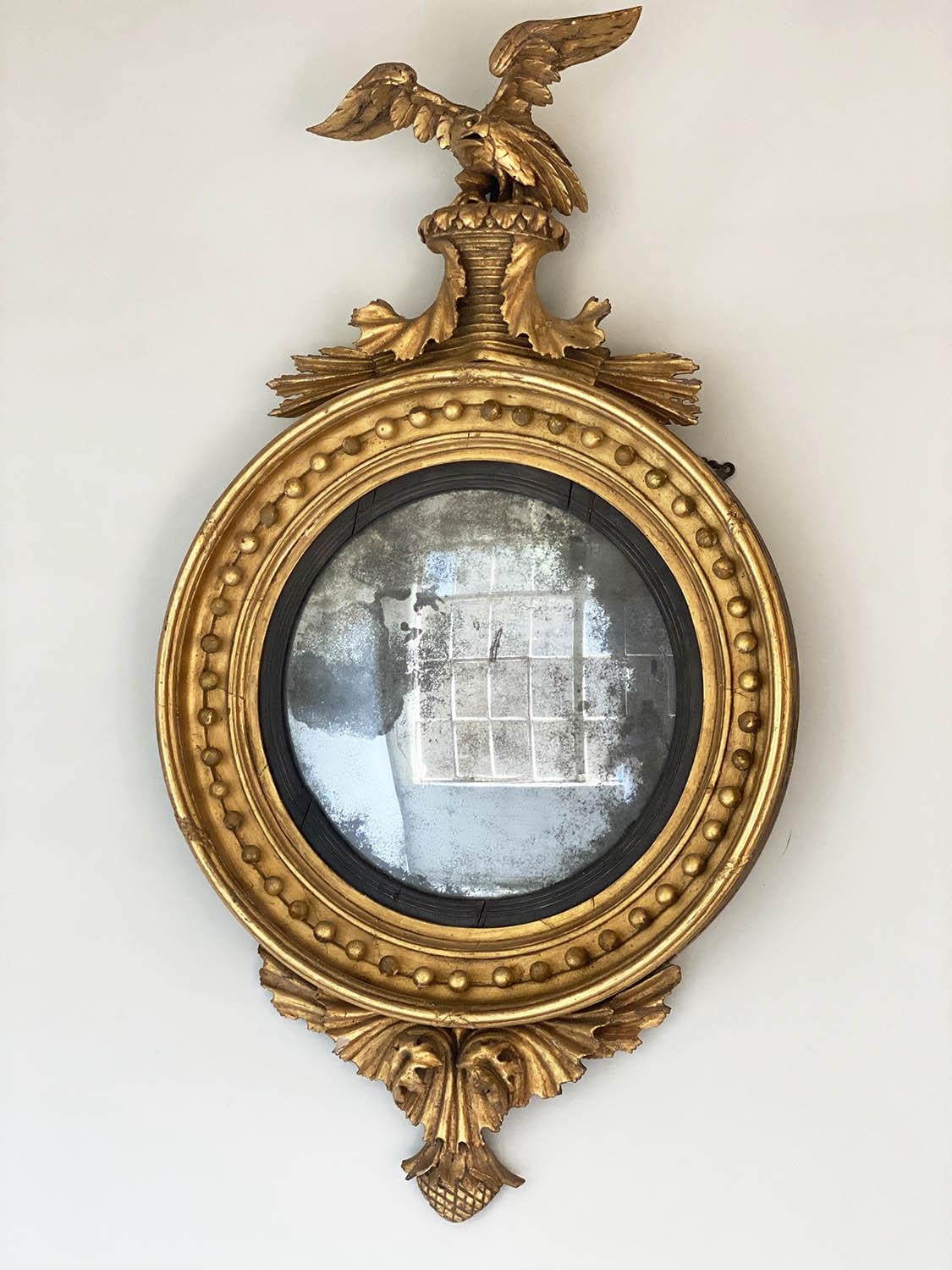 CONVEX WALL MIRROR, Regency giltwood, circular sphere decorated frame, with carved eagle crest,