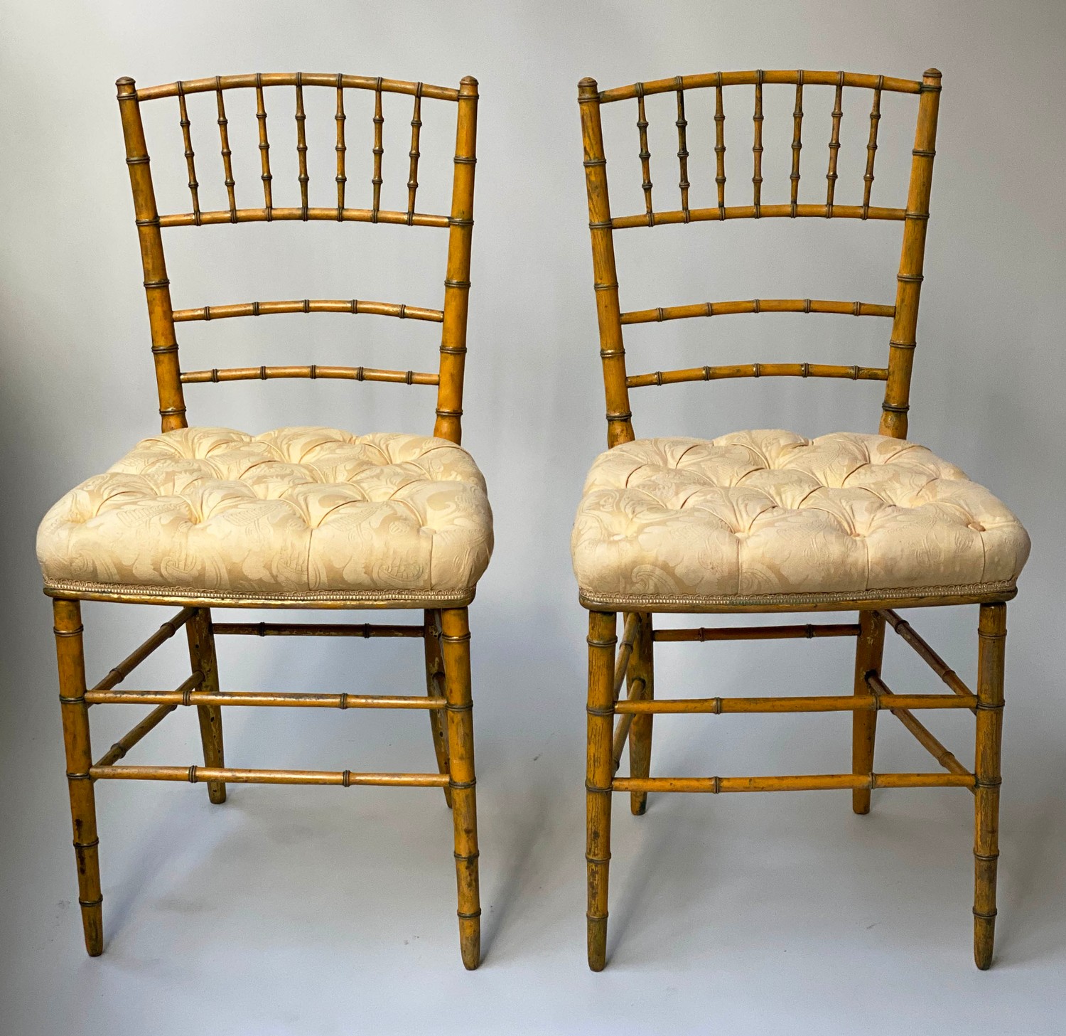 SALON CHAIRS, a pair, 19th century faux bamboo framed with button yellow satin seats. (2)