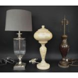 TABLE LAMPS, three various including red spiral glass, clear glass and nickel, early 20th century