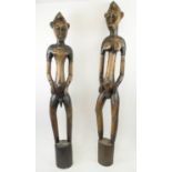 SENUFO FIGURES, a pair, from Ivory Coast, carved wood, 135cm H. (2)
