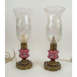 LAMPS, a pair, 19th century French, modified oil lamps with ruby foliate decorated glass and