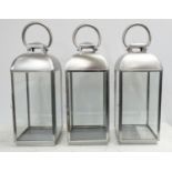 STORM LANTERNS, three, 60cm H polished metal. (3)