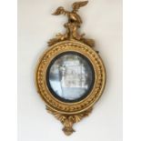 CONVEX WALL MIRROR, Regency giltwood, circular sphere decorated frame, with carved eagle crest,