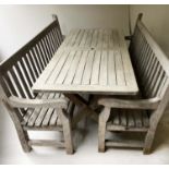 GARDEN TABLE AND BENCHES, weathered teak of substantial slatted form with X trestle supports