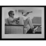 AFTER JOHN DOWNING, 74cm x 54cm, Steve McQueen with gun, framed and glazed.