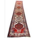 ANTIQUE PERSIAN SERAPI LONG RUNNER, 445cm x 87cm.