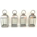 STORM LANTERNS, four, 45cm H, contemporary polished metal. (4)