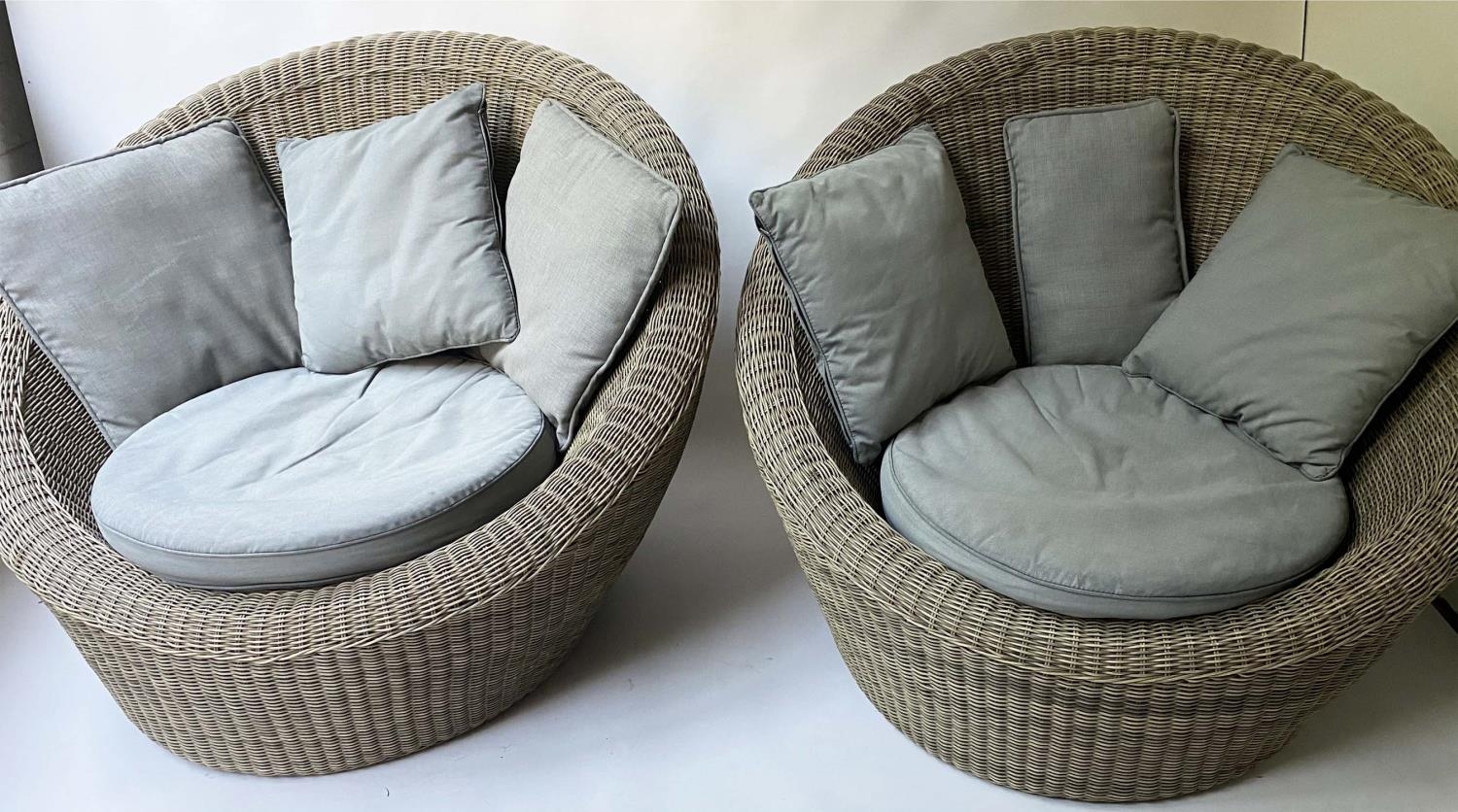 EASY ARMCHAIRS, 122cm W, a pair, grey rattan, of rounded design, each with grey seat and scatter
