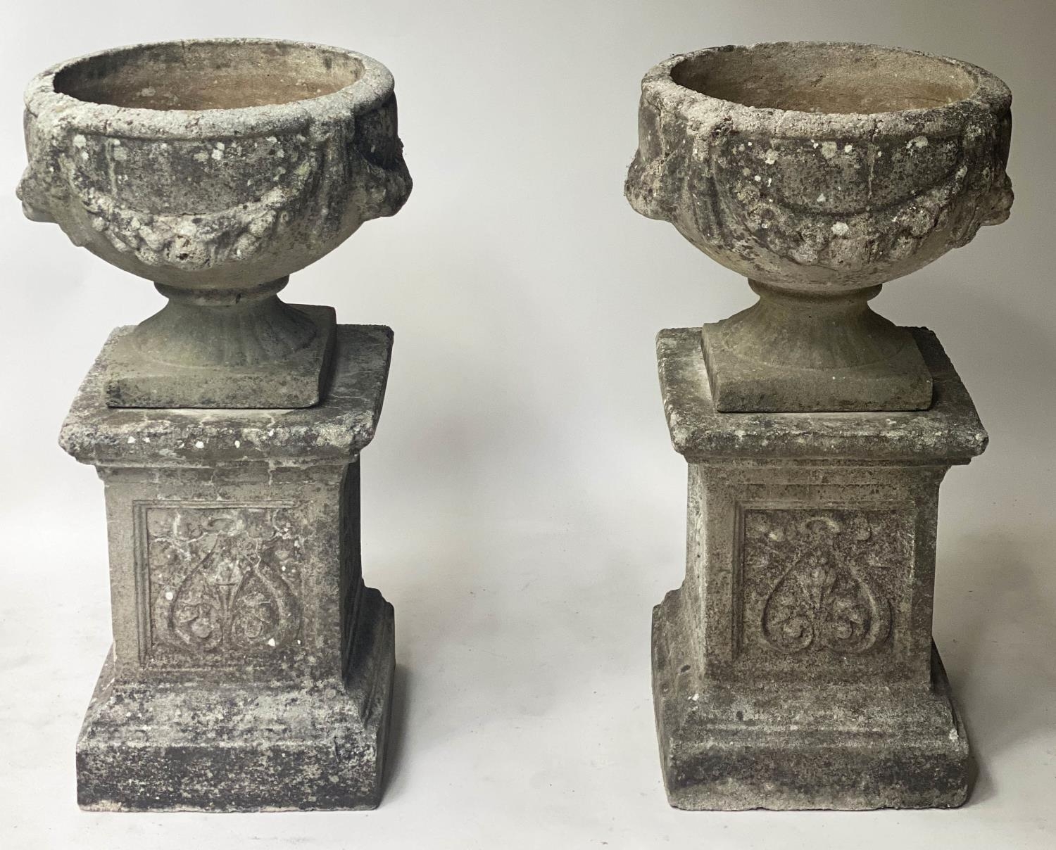 GARDEN PLANTERS, a pair, well weathered reconstituted stone with swag decorated urns on anthemion