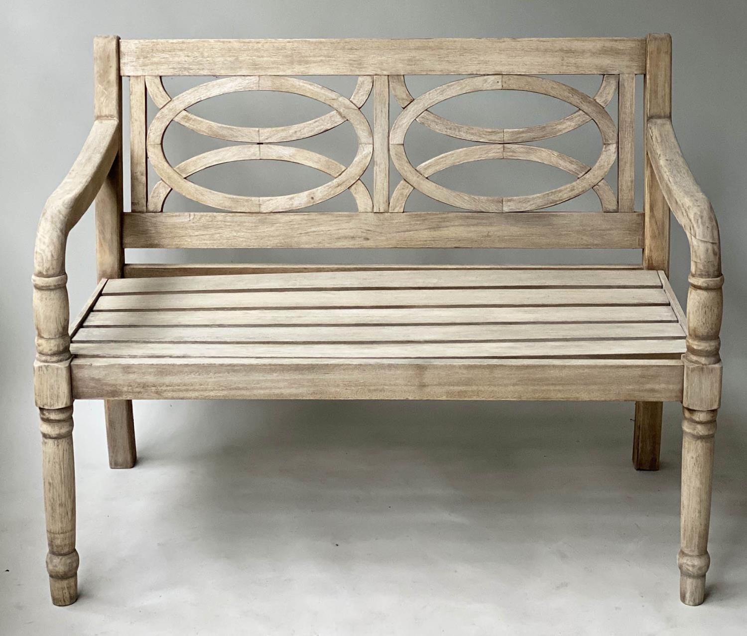 GARDEN BENCH, colonial veranda style weathered teak with circles slatted back and downswept arms,