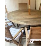 GARDEN TABLE AND CHAIRS, a set weathered teak slatted with circular folding table and eight