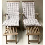 STEAMER ARMCHAIRS, a pair, weathered teak and slatted reclining with detachable foot rests and