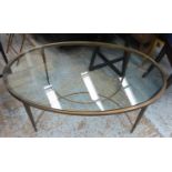 BAKER MANNER LOW COCKTAIL TABLE, 123cm W x 43.5cm H x 77cm D with an oval glass top.