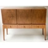 MANNER OF A. COX SIDEBOARD, 1970's figured walnut with three drawers and three doors with tall