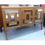 SIDEBOARD, with three partial mirrored slip fronted doors enclosing shelves, 132cm L x 90cm H x 50cm