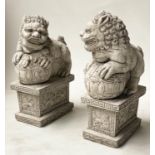 GARDEN DOGS OF FOO, an opposing pair, reconstituted stone with Greek key and lion plinths, 54cm